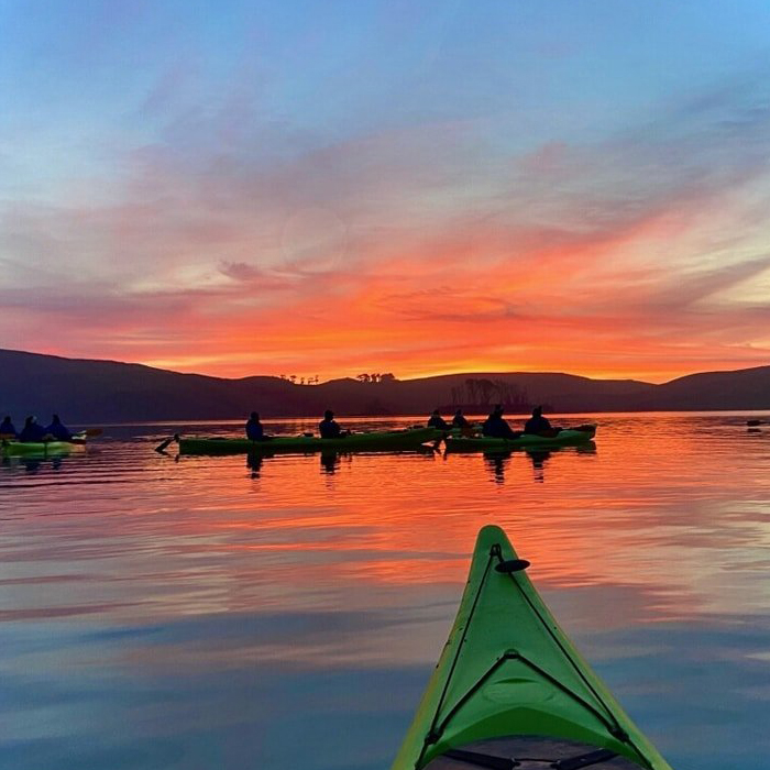 Group Of Kayakers At Sunset