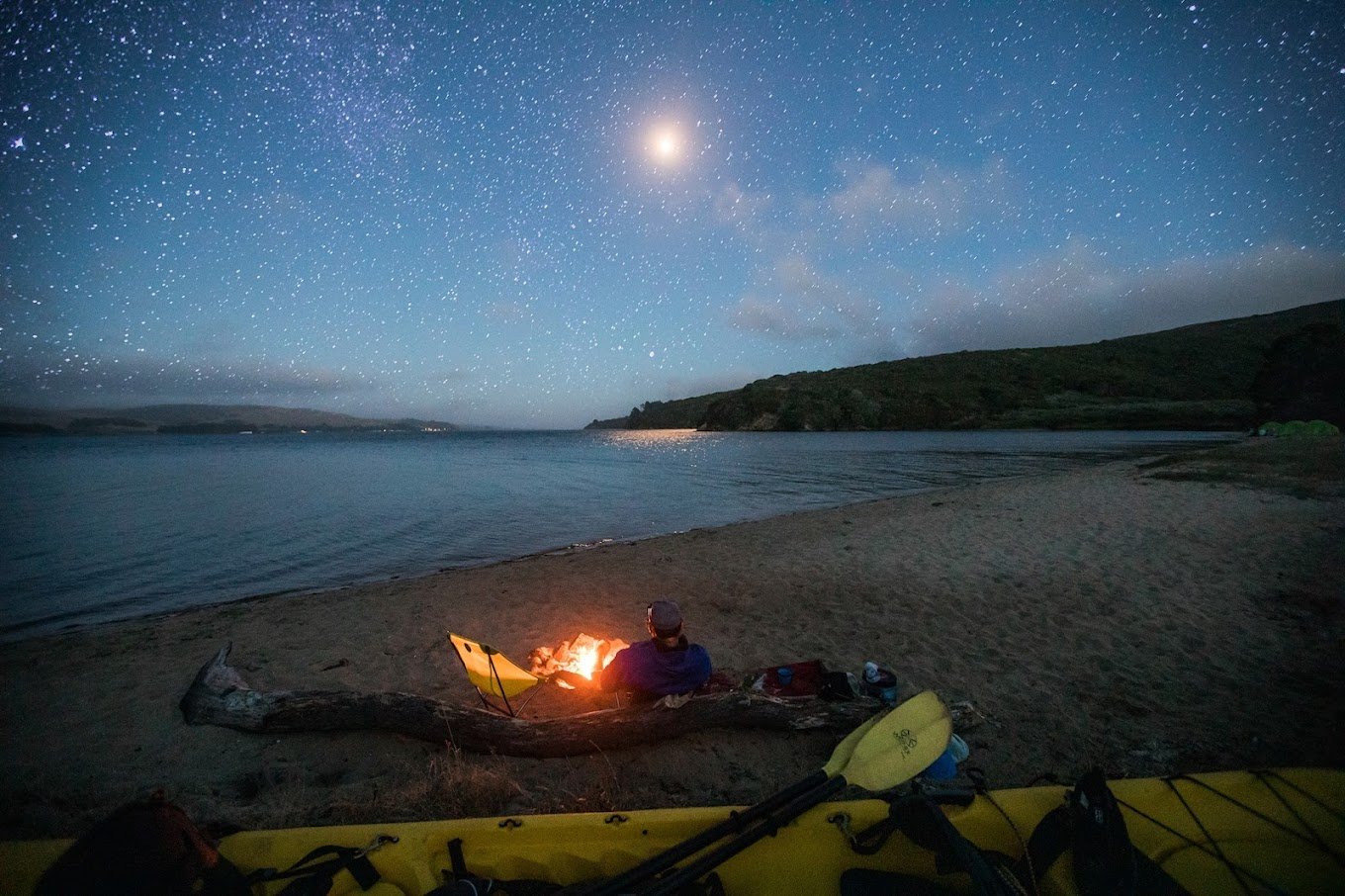 Kayaker On Beach With Fire At Night