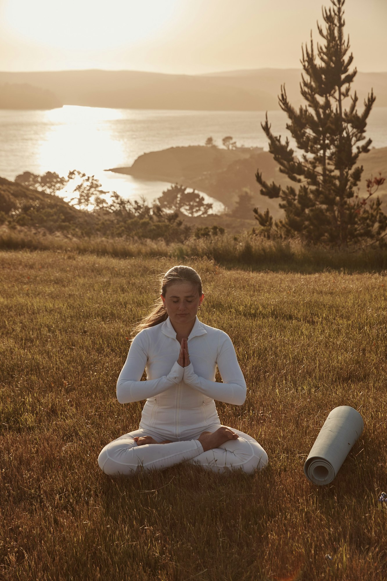 Woman doing yoga on Tower Hill in Lodge at Marconi on Tomales Bay