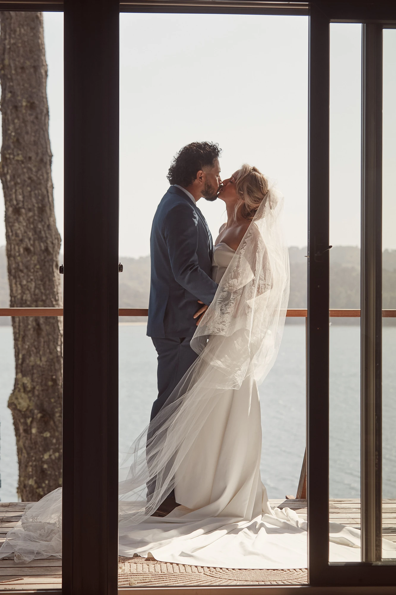 photo of a married couple on the deck of the a-frame