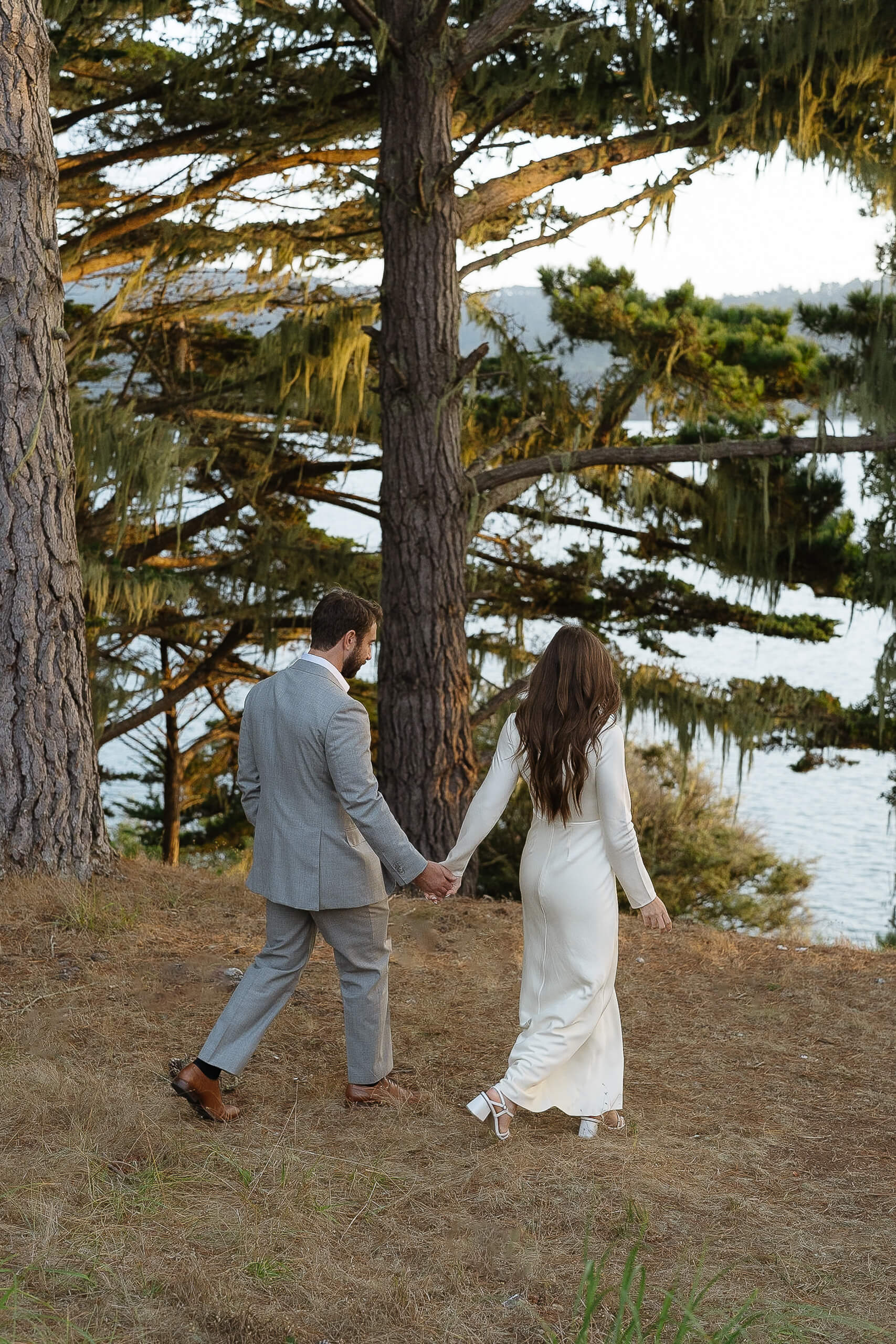 Photo of wedding couple walking down towards Tomales Bay