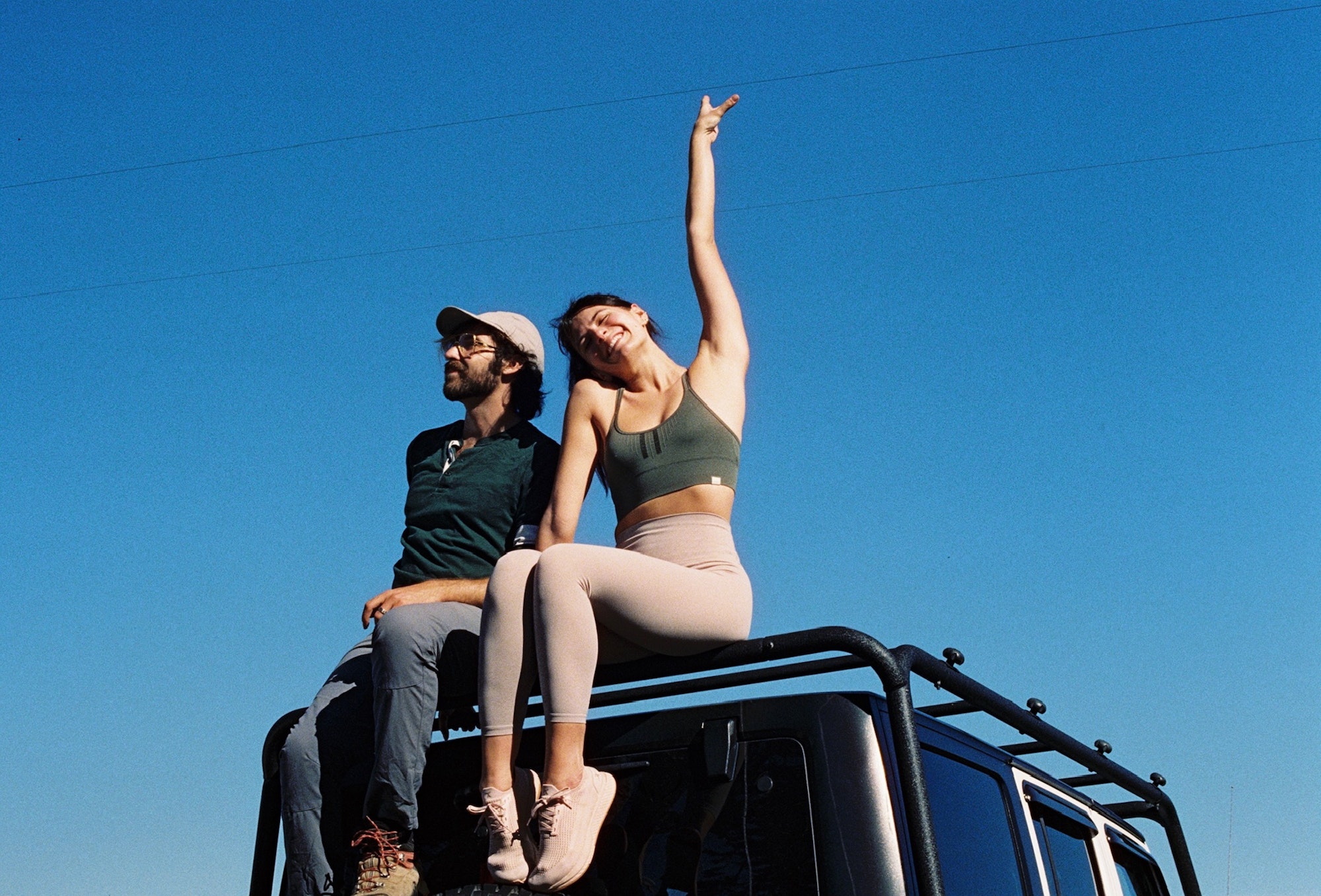 Couple on top of car