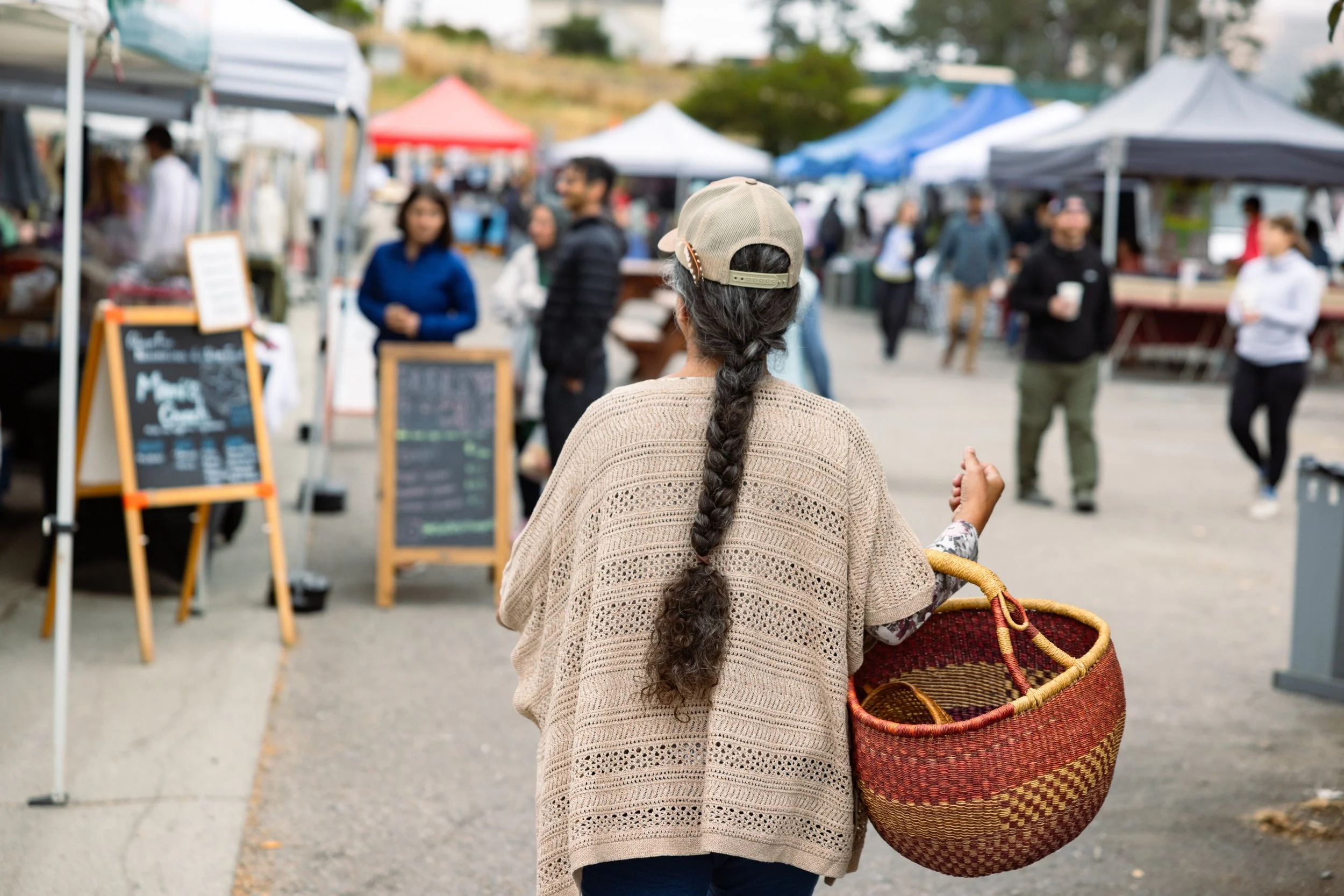 woman walking through farmers' market