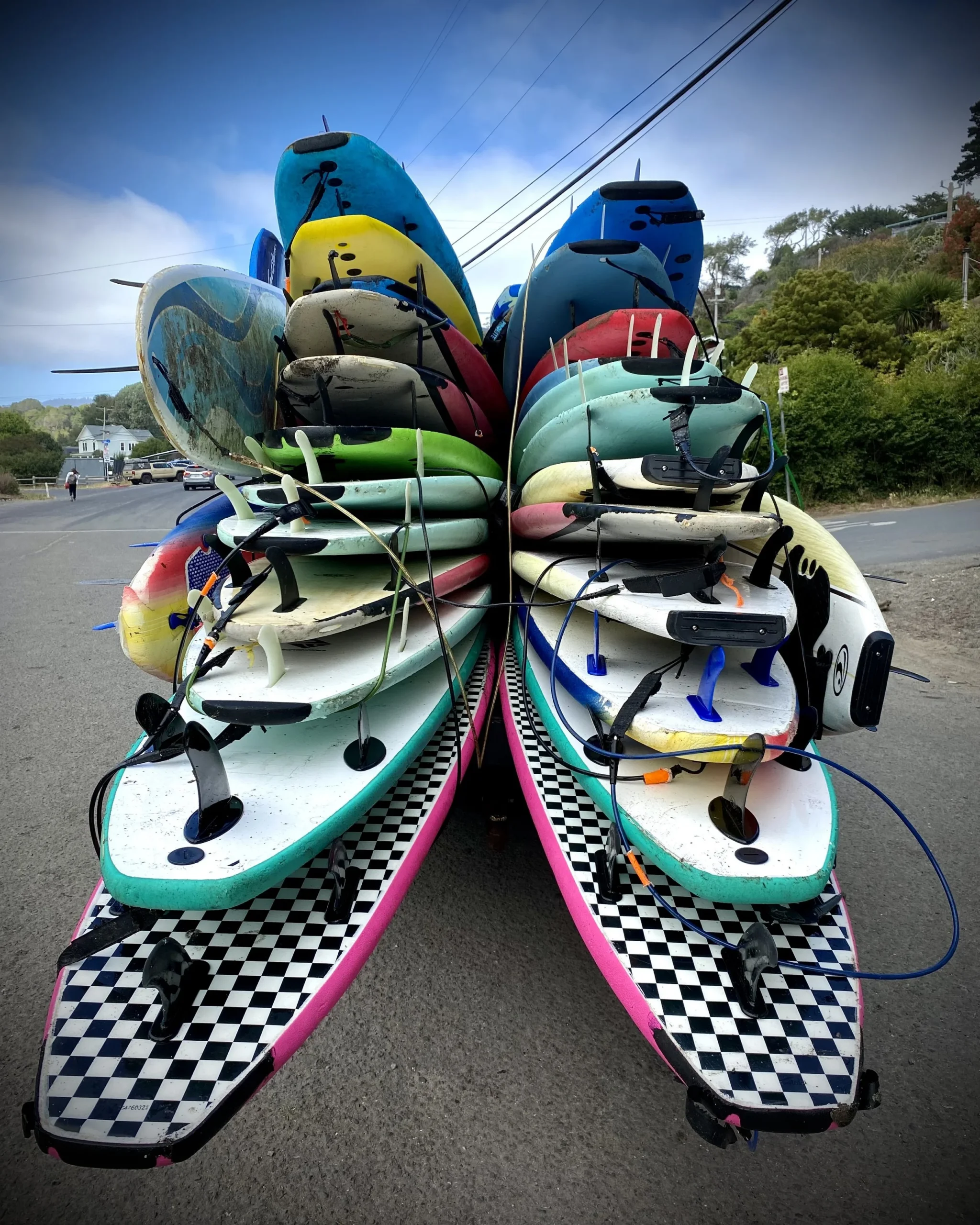 surf boards stacked on top of one another